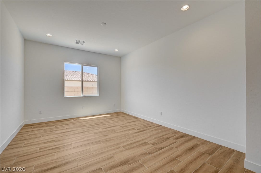 5689 Searching Bear Court, Las Vegas, NV 89149 Sun-filled room featuring modern recessed lighting and durable tile flooring, perfect for versatile living.