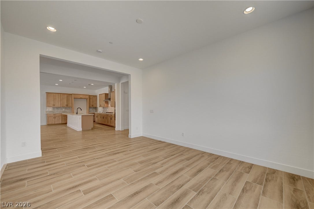 5689 Searching Bear Court, Las Vegas, NV 89149 An open floorplan seamlessly connects the living space to a well-appointed kitchen, ideal for modern entertaining.