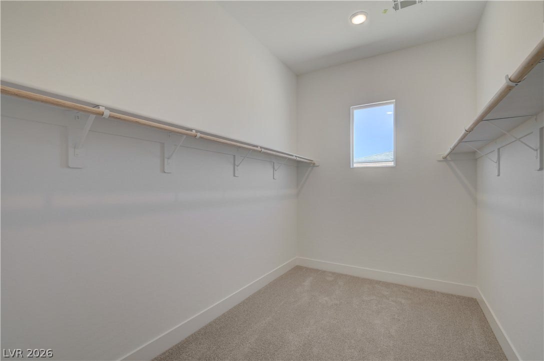 5689 Searching Bear Court, Las Vegas, NV 89149 A spacious walk-in closet offers ample storage and natural light through a well-placed window.