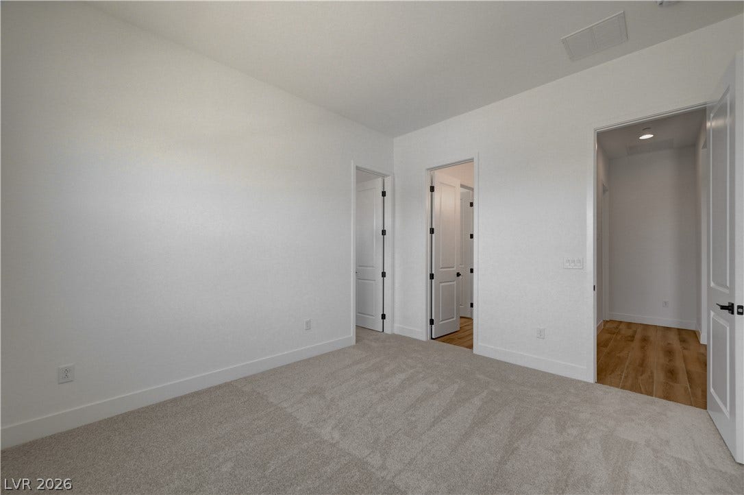 5689 Searching Bear Court, Las Vegas, NV 89149 An airy bedroom presents plush carpeting, offering a comfortable and serene retreat.