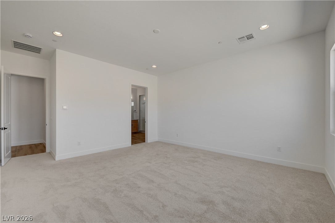 5689 Searching Bear Court, Las Vegas, NV 89149 A spacious, naturally illuminated room featuring plush carpeting and pristine white walls, ready for your personal touch.