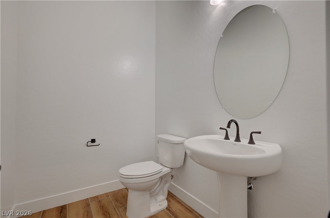 5689 Searching Bear Court, Las Vegas, NV 89149 A pristine powder room offers sleek fixtures and a practical layout for guest convenience.