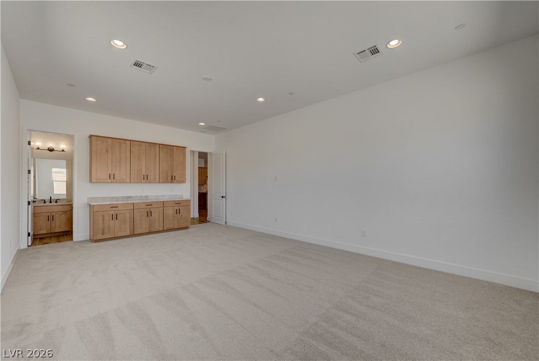 5689 Searching Bear Court, Las Vegas, NV 89149 A spacious secondary living area with abundant cabinetry, perfect for storage or a casual bar.