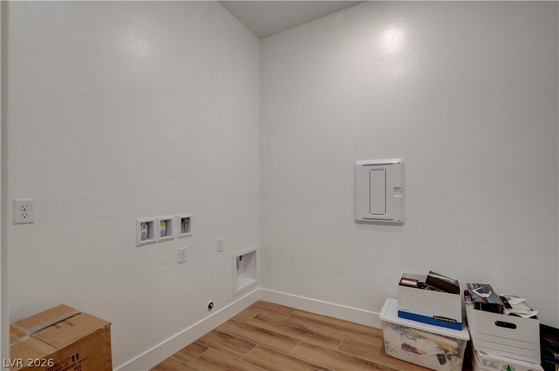 5689 Searching Bear Court, Las Vegas, NV 89149 A dedicated utility space with wood-look tile flooring awaits your personal touch.