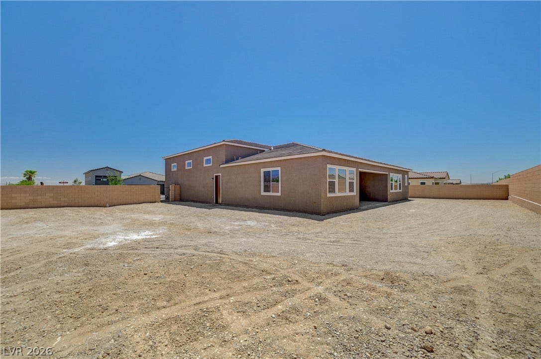 5689 Searching Bear Court, Las Vegas, NV 89149 A spacious, bare yard awaits your landscaping vision, with a contemporary home situated under a clear sky.