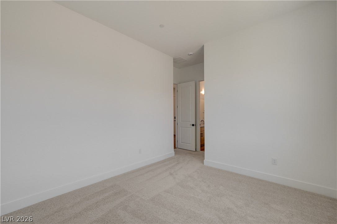 5689 Searching Bear Court, Las Vegas, NV 89149 A spacious room offers comfortable carpeting, ready for personalization.