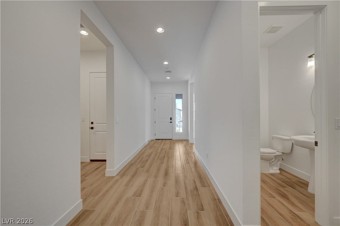 5689 Searching Bear Court, Las Vegas, NV 89149 A welcoming entry hall with recessed lighting and a sleek tiled floor flows into a convenient half bathroom.