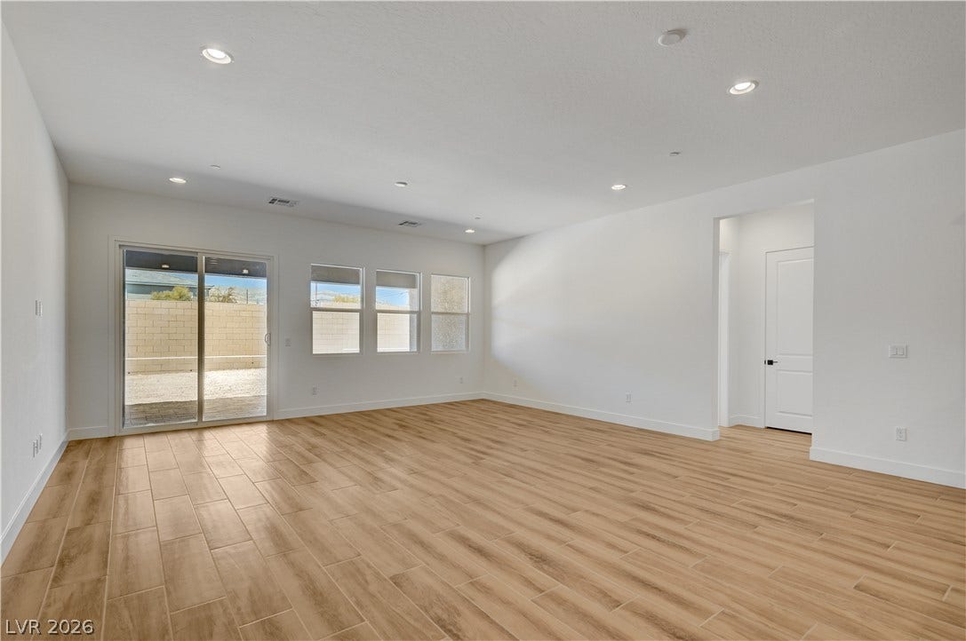 5689 Searching Bear Court, Las Vegas, NV 89149 Sun-filled living space featuring durable tile flooring and a sliding glass door to the private yard.