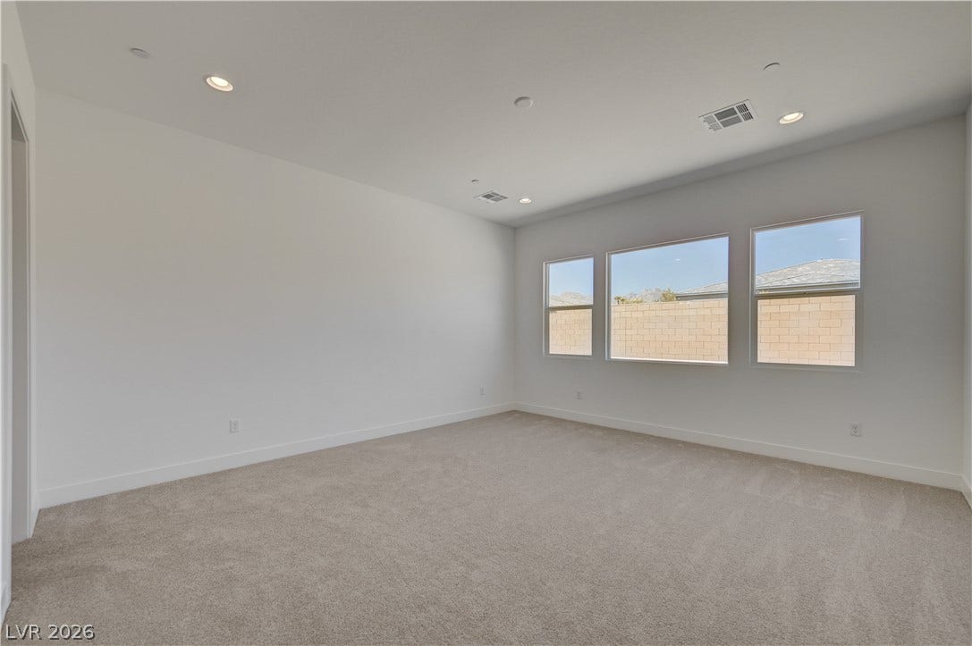 5689 Searching Bear Court, Las Vegas, NV 89149 A spacious room offers ample natural light and clean lines, ready for personal touches.