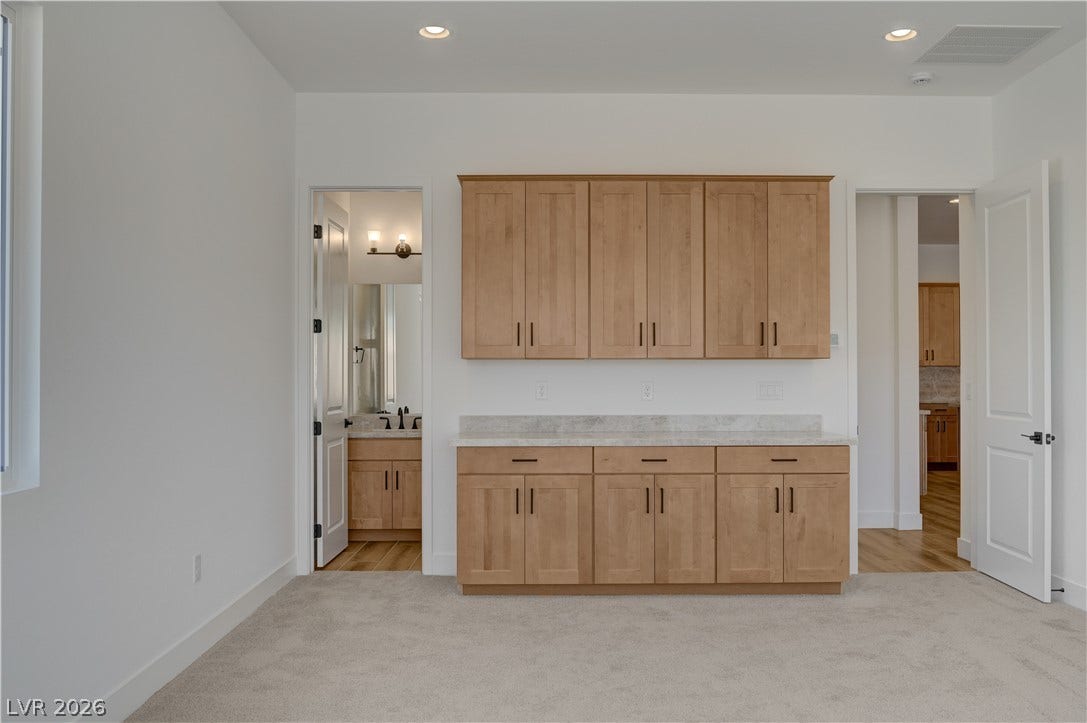 5689 Searching Bear Court, Las Vegas, NV 89149 Ample cabinetry and a convenient countertop offer practical storage in this versatile room.