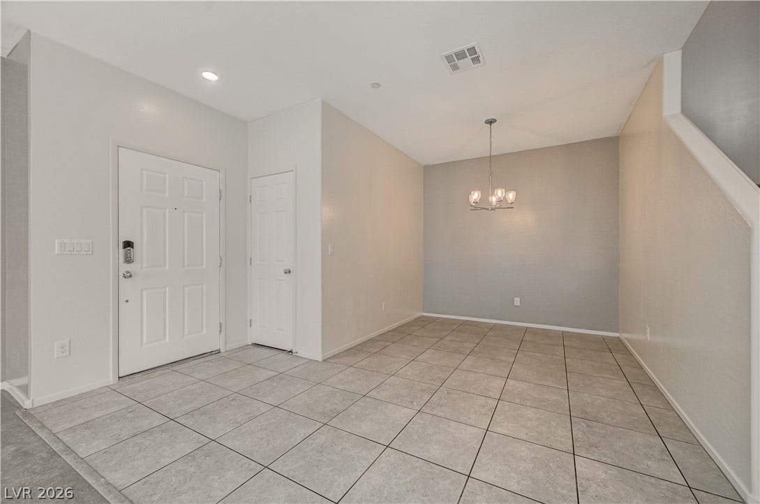 2455 Sunflower Days Avenue, #1056, North Las Vegas, NV 89031 Gleaming tile floors and a classic light fixture define this versatile entry and dining space.