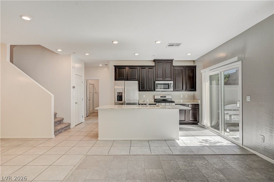 2455 Sunflower Days Avenue, #1056, North Las Vegas, NV 89031 An open floorplan connects the tile-floored living area directly to the kitchen.