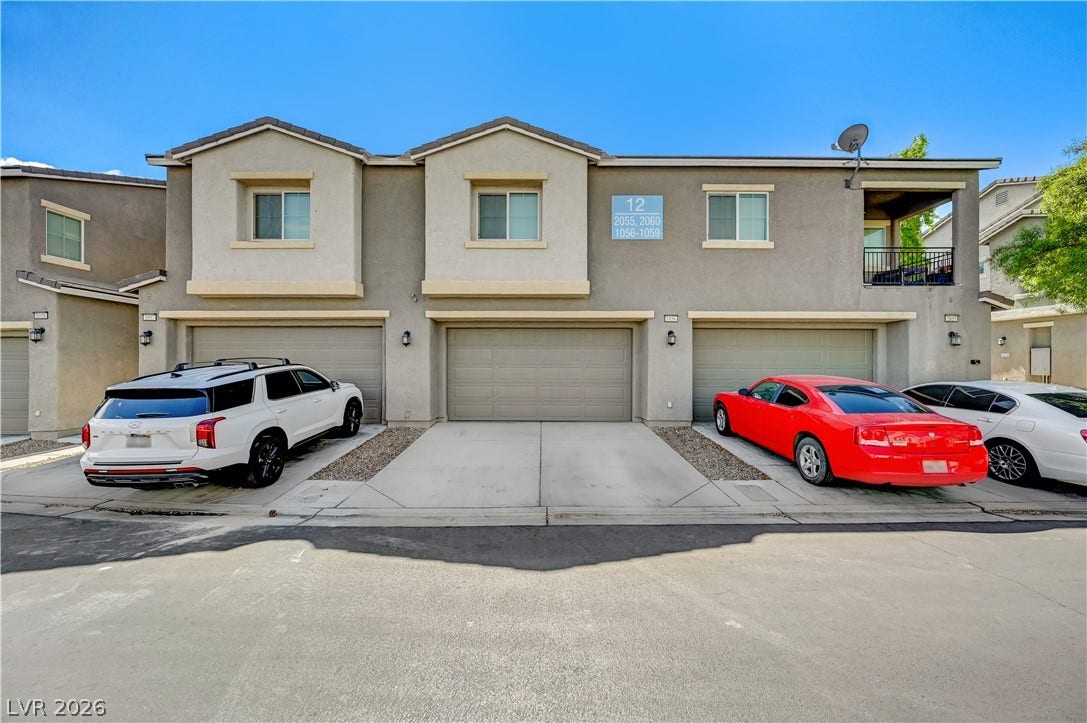 2455 Sunflower Days Avenue, #1056, North Las Vegas, NV 89031 Concrete driveways lead directly to attached garages beneath a clean stucco exterior.