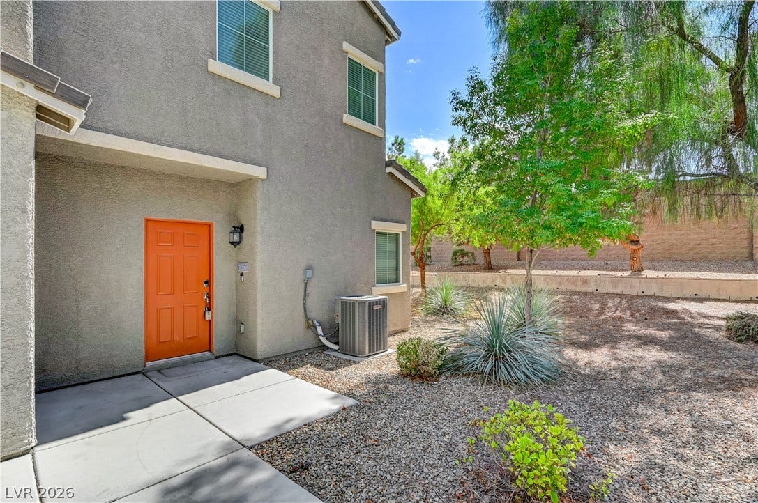 2455 Sunflower Days Avenue, #1056, North Las Vegas, NV 89031 An inviting entrance with a modern door welcomes visitors to this stucco home.