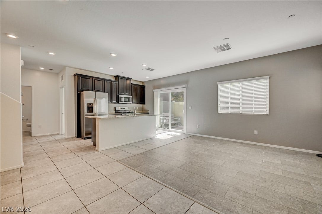 2455 Sunflower Days Avenue, #1056, North Las Vegas, NV 89031 An open floorplan seamlessly connects the bright living area to a modern kitchen.
