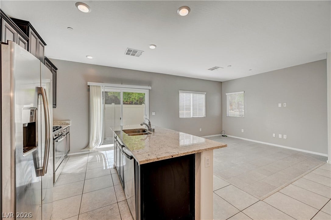 2455 Sunflower Days Avenue, #1056, North Las Vegas, NV 89031 An open kitchen layout flows seamlessly into the living area under recessed lighting.