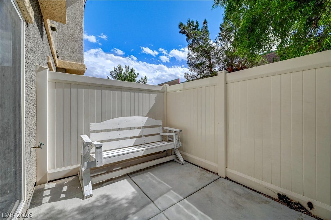 2455 Sunflower Days Avenue, #1056, North Las Vegas, NV 89031 Private outdoor patio enclosed by high fencing offers a quiet retreat under open skies.