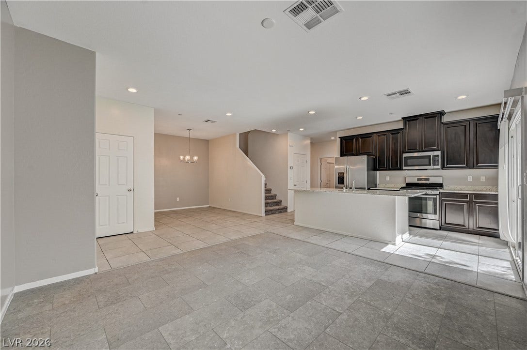 2455 Sunflower Days Avenue, #1056, North Las Vegas, NV 89031 Tile flooring spans this open-concept main level connecting the kitchen and dining area.