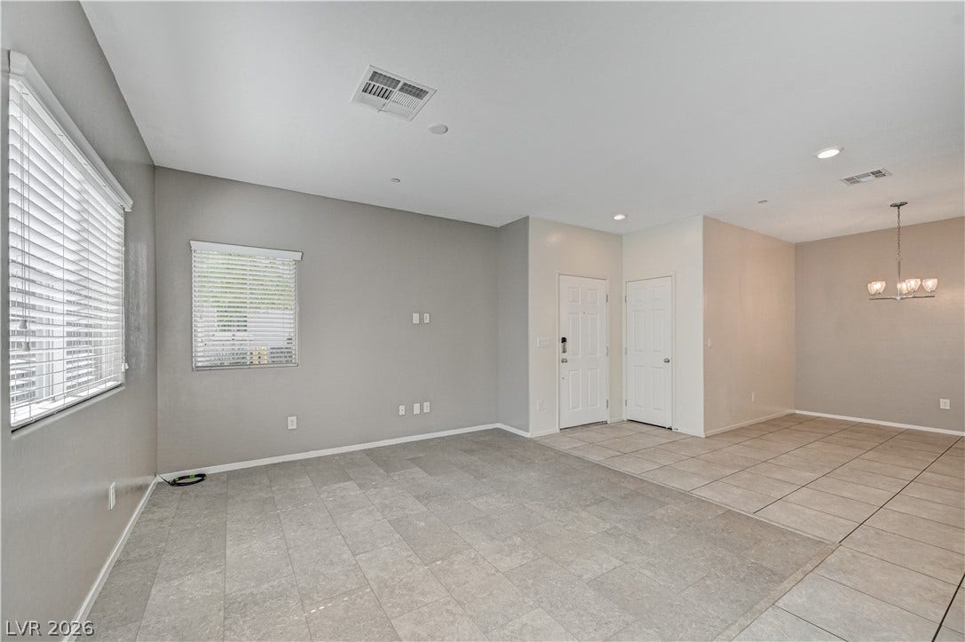 2455 Sunflower Days Avenue, #1056, North Las Vegas, NV 89031 Gleaming tile floors and natural light from large windows define this versatile open living space.
