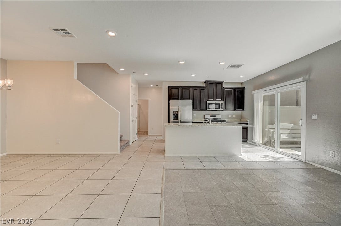 2455 Sunflower Days Avenue, #1056, North Las Vegas, NV 89031 Tiled floors and recessed lighting anchor this open-concept layout connecting the kitchen and living areas.