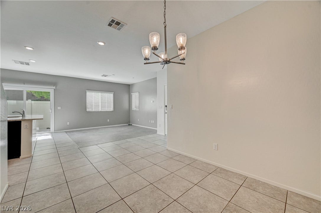 2455 Sunflower Days Avenue, #1056, North Las Vegas, NV 89031 Ceramic tile flooring and recessed lighting connect this versatile dining space to the main living area.