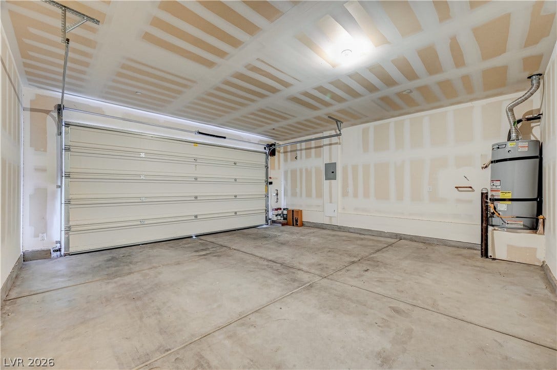 2455 Sunflower Days Avenue, #1056, North Las Vegas, NV 89031 A spacious garage features durable concrete flooring and an overhead door system.