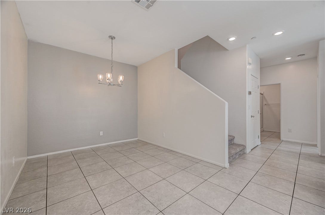 2455 Sunflower Days Avenue, #1056, North Las Vegas, NV 89031 Tiled floors and a simple dining area connect seamlessly with the stairway.