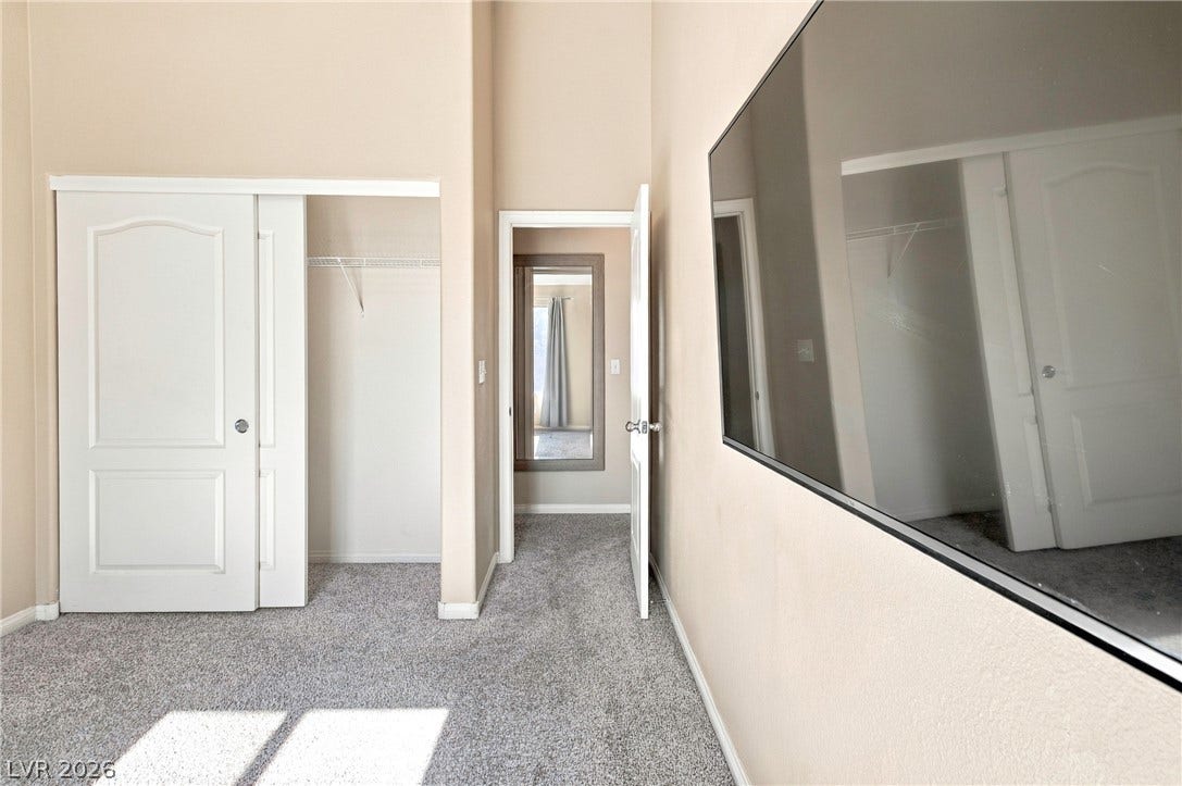 2752 Fountain Vista Lane, Henderson, NV 89074 High ceilings and neutral carpet define this secondary bedroom with a built-in closet.