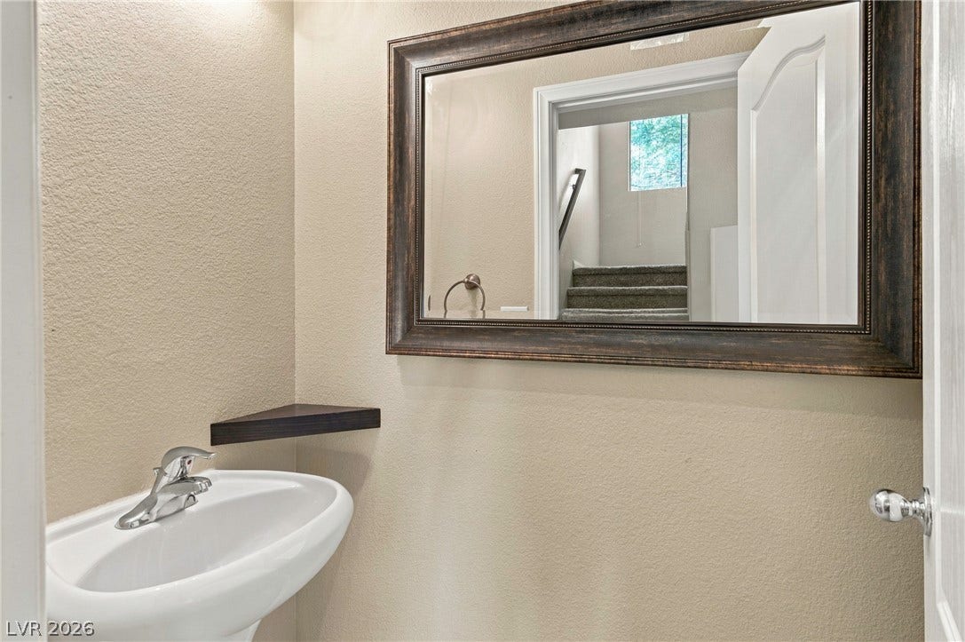 2752 Fountain Vista Lane, Henderson, NV 89074 An elegant pedestal sink and framed vanity mirror grace this powder room.