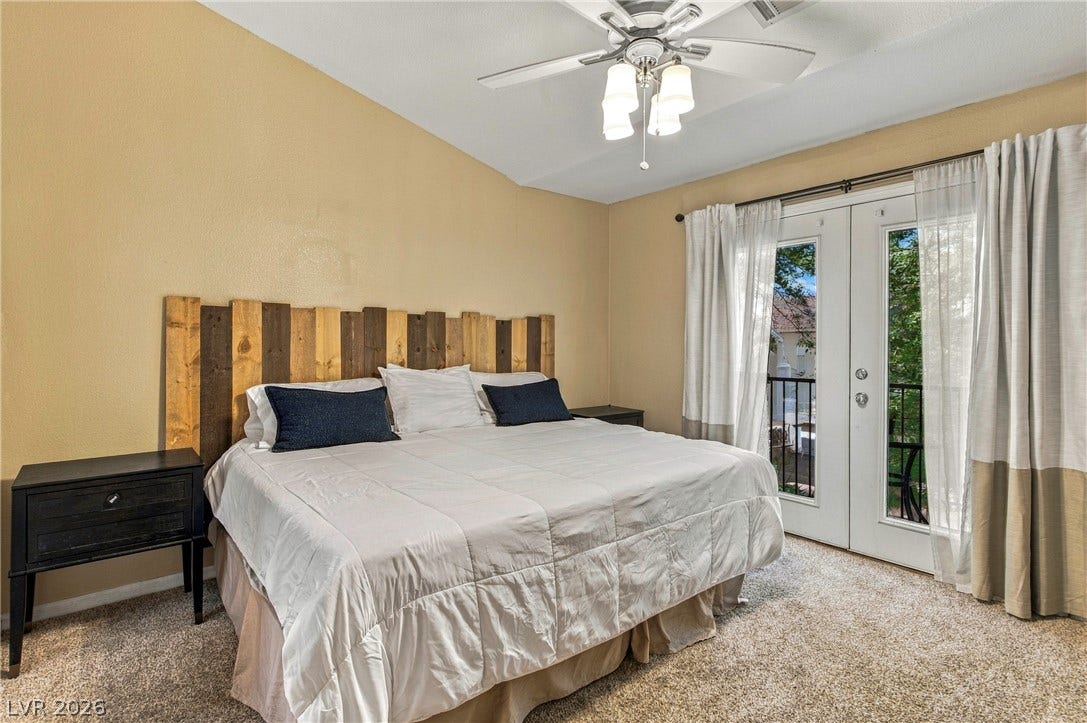 2752 Fountain Vista Lane, Henderson, NV 89074 Glass double doors open to a private balcony from this vaulted ceiling bedroom.
