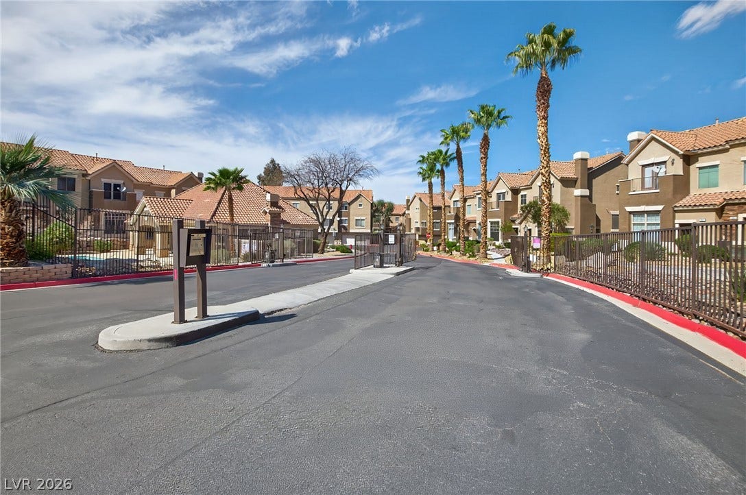 2752 Fountain Vista Lane, Henderson, NV 89074 Secure gated entry introduces this modern residential community framed by palm trees.