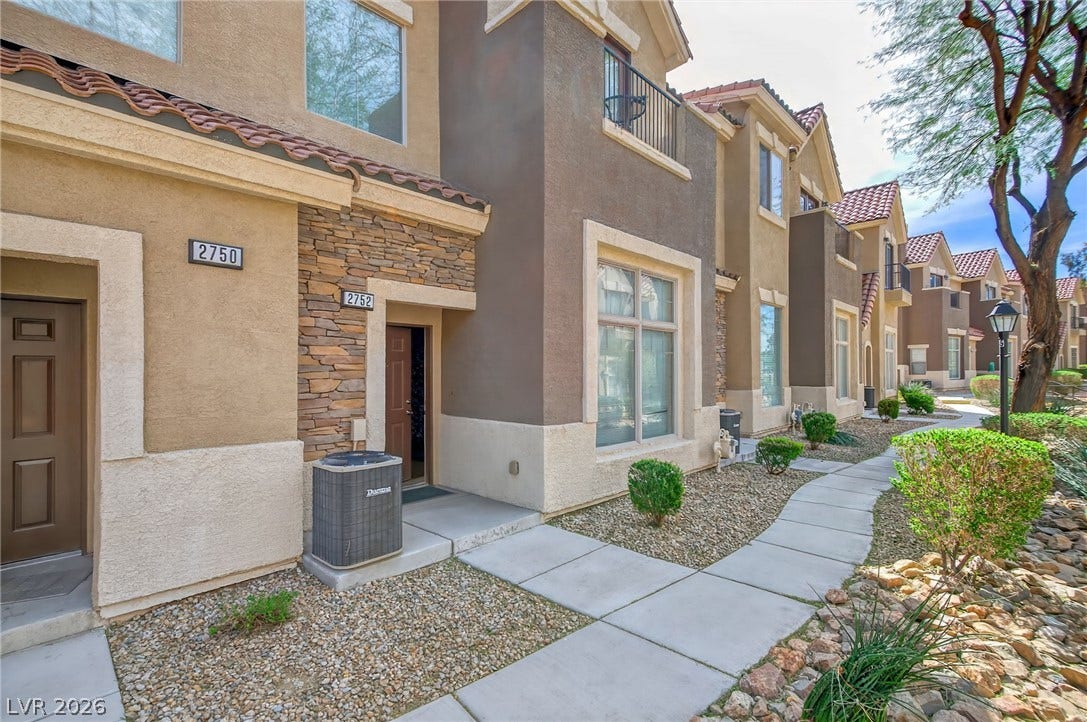 2752 Fountain Vista Lane, Henderson, NV 89074 A paved concrete walkway leads to the entryway of this multi-level home.