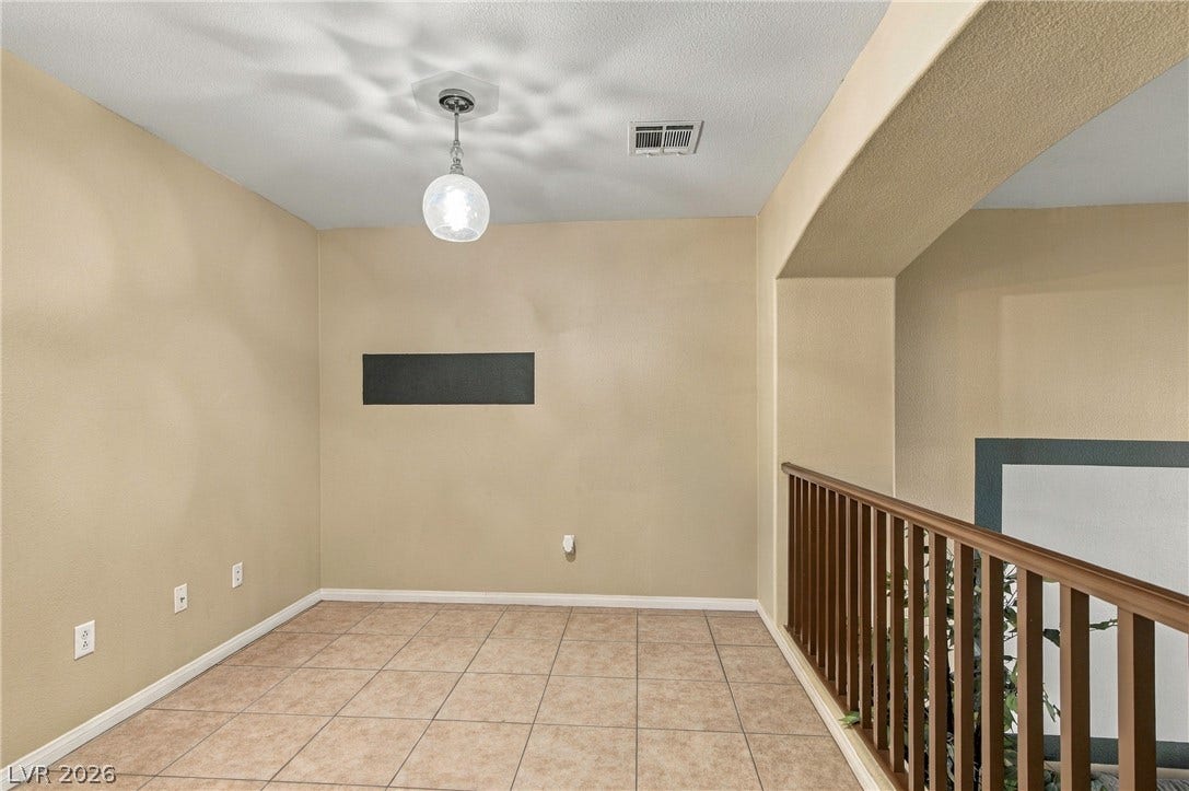 2752 Fountain Vista Lane, Henderson, NV 89074 An upper-level loft area features durable tile flooring and a protective wooden railing.