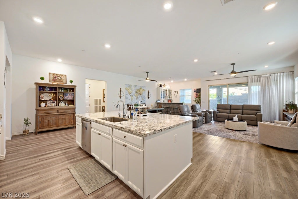 752 Dorsey Falls Street, Henderson, NV 89011 Gleaming stone countertops and a spacious island anchor this expansive, open-concept layout.