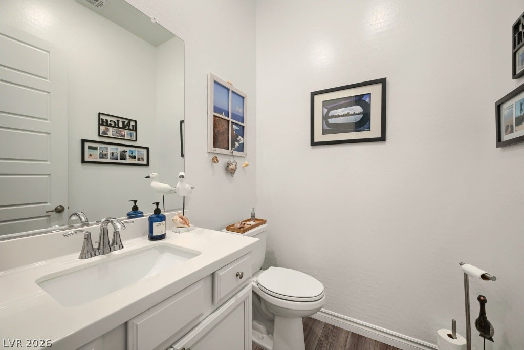 752 Dorsey Falls Street, Henderson, NV 89011 Sleek vanity surfaces and modern fixtures define this light-filled half bath.