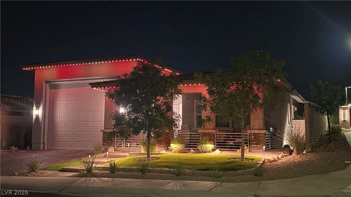 752 Dorsey Falls Street, Henderson, NV 89011 Dramatic exterior lighting accentuates the modern facade and manicured front landscaping at night.