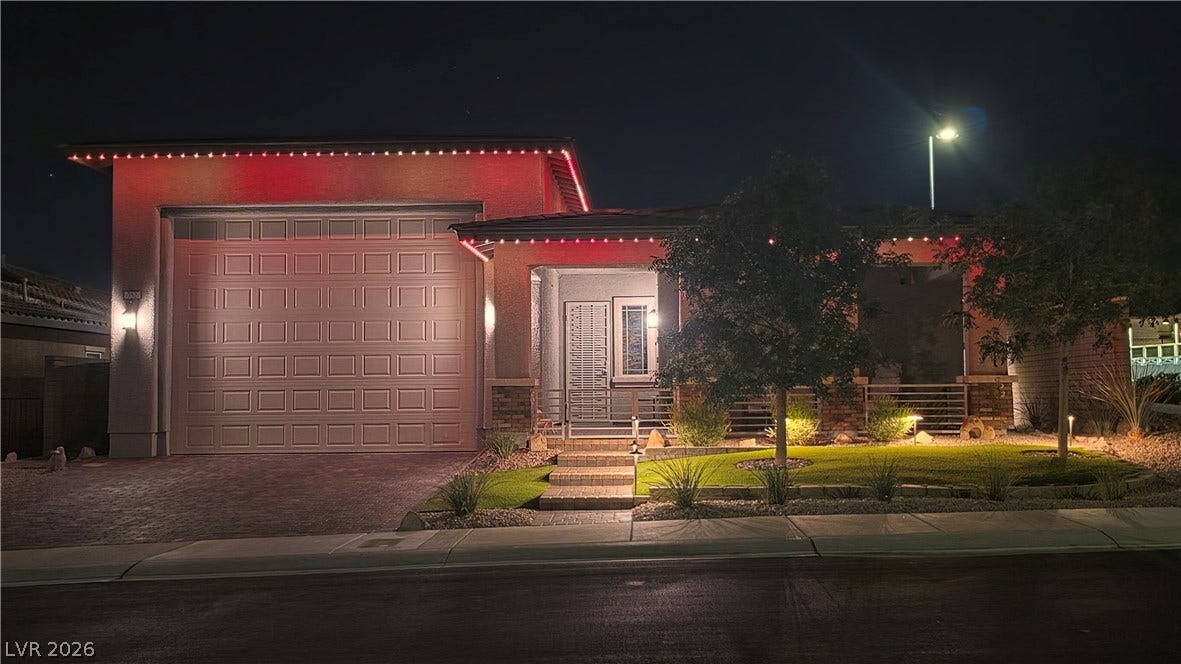 752 Dorsey Falls Street, Henderson, NV 89011 Accent lighting illuminates the contemporary stucco facade and manicured front landscaping at night.