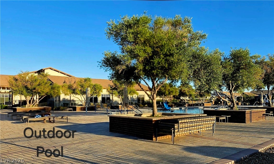 752 Dorsey Falls Street, Henderson, NV 89011 An expansive paved sun deck surrounds the sparkling community pool under clear blue skies.