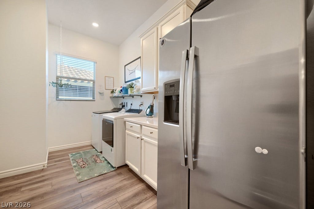 752 Dorsey Falls Street, Henderson, NV 89011 Streamlined cabinetry and classic plank flooring define this functional home utility space.