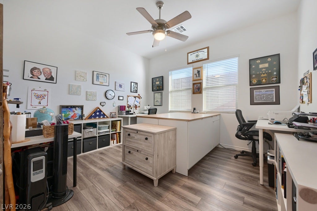 752 Dorsey Falls Street, Henderson, NV 89011 Gleaming wood-look floors and high ceilings define this versatile home workspace.