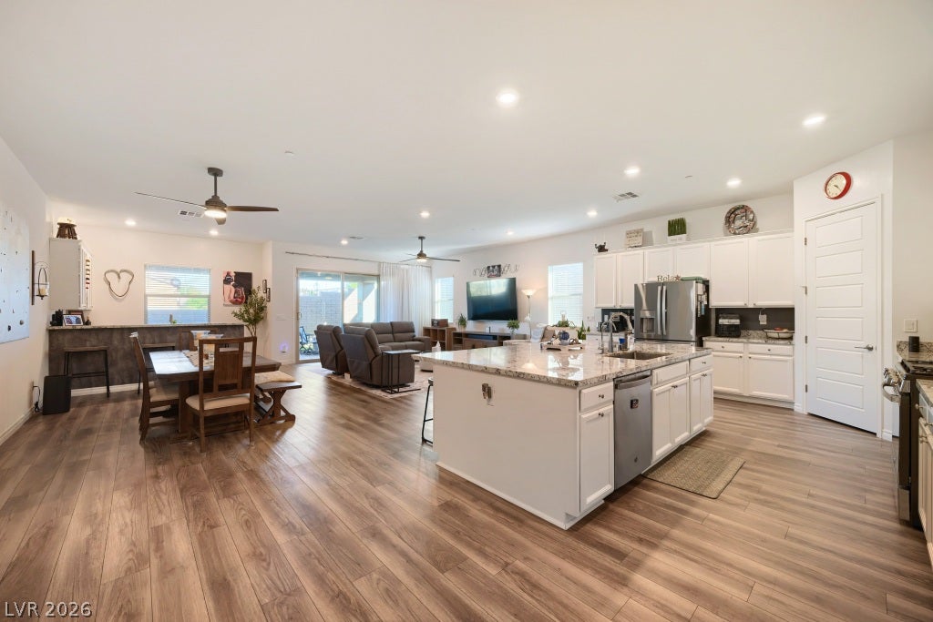 752 Dorsey Falls Street, Henderson, NV 89011 Gleaming wood-look floors anchor a sprawling open concept layout connecting the kitchen and living areas.