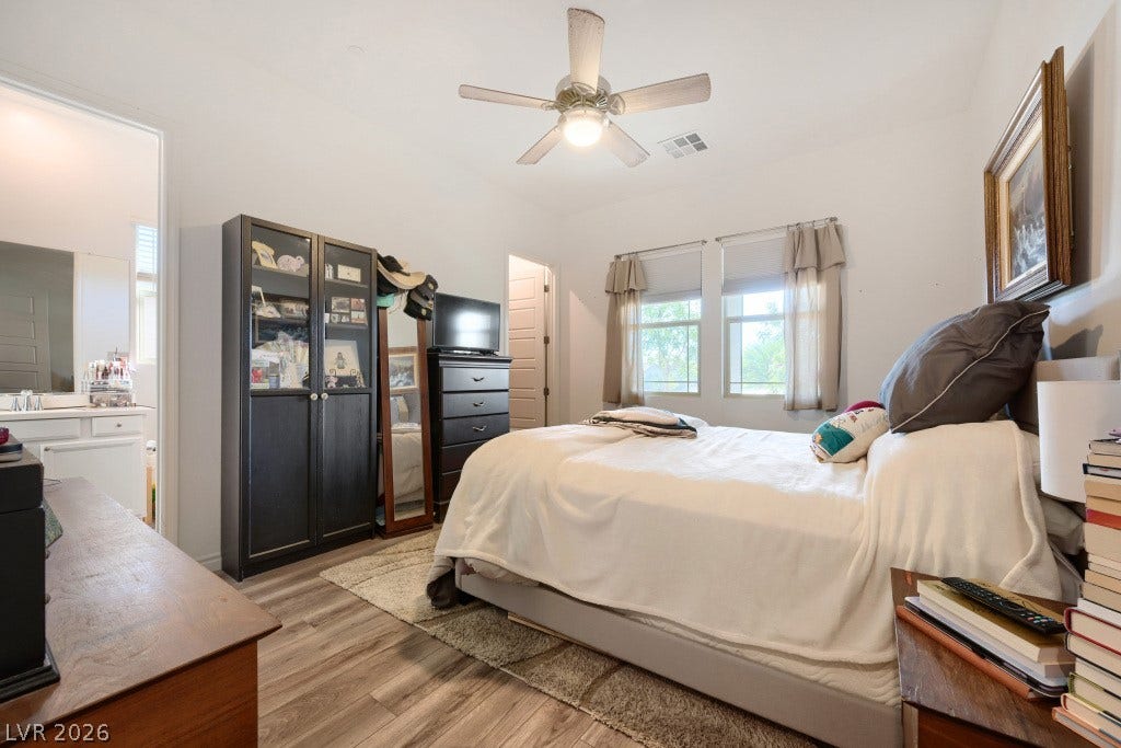 752 Dorsey Falls Street, Henderson, NV 89011 Polished wood-plank flooring and ample natural light define this comfortable private retreat.