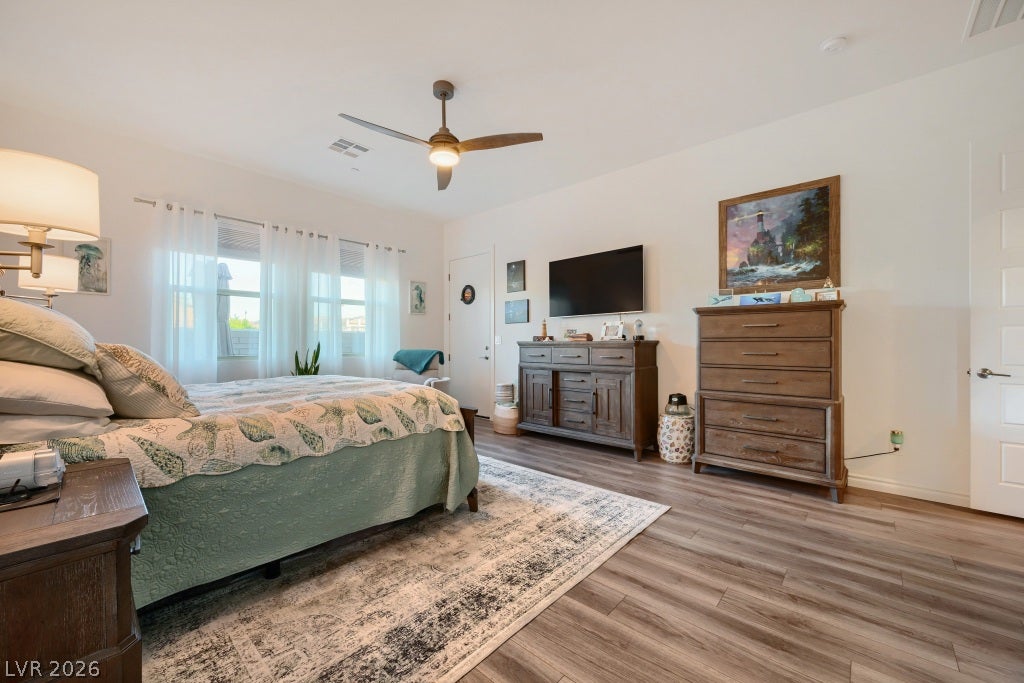 752 Dorsey Falls Street, Henderson, NV 89011 Gleaming wood-inspired floors and abundant natural light define this welcoming bedroom retreat.