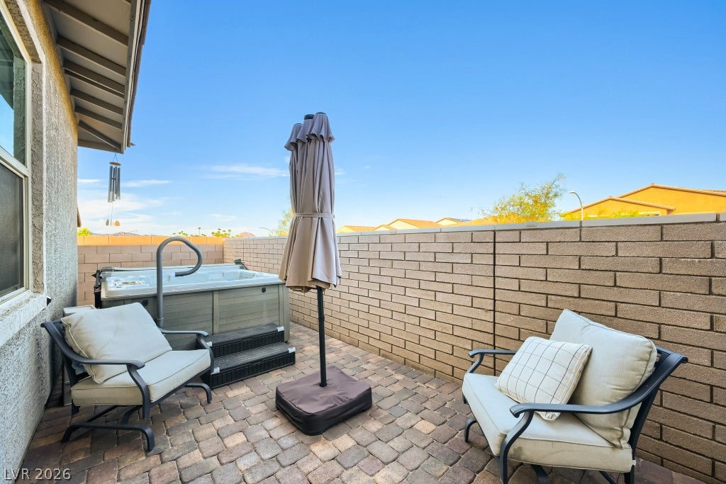 752 Dorsey Falls Street, Henderson, NV 89011 An inviting paver stone patio features a private hot tub enclosed by solid block fencing.