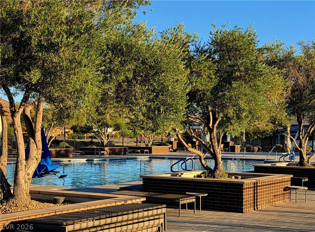 752 Dorsey Falls Street, Henderson, NV 89011 Mature trees frame the expansive community swimming pool lined with stone-capped brick planters.