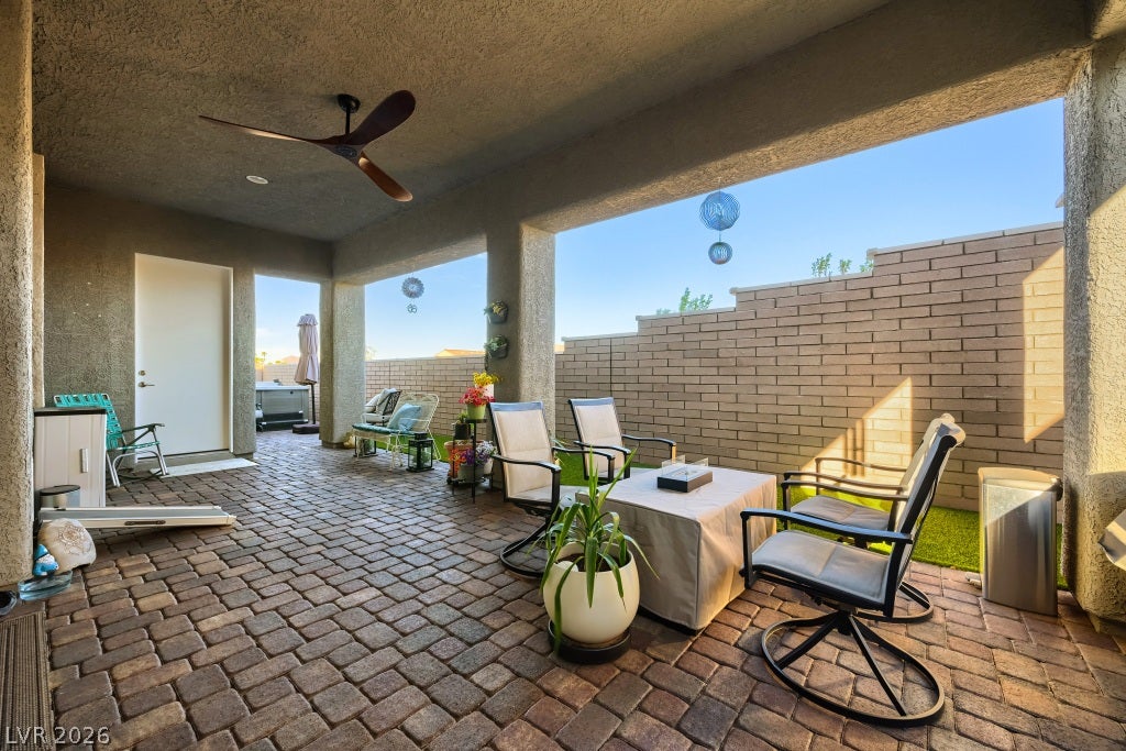 752 Dorsey Falls Street, Henderson, NV 89011 An inviting covered patio features extensive paver flooring and stucco pillars opening to the yard.