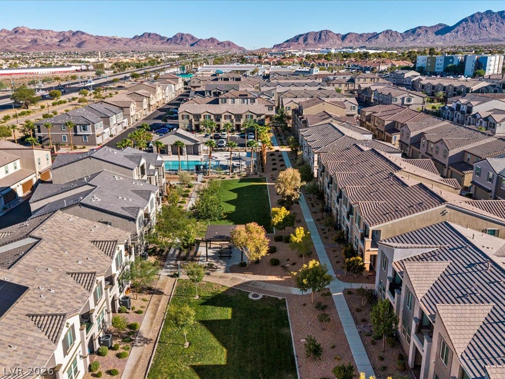 671 Foam Flower Lane, Henderson, NV 89015 An aerial perspective showcases the manicured green space nestled between modern multi-family residences.