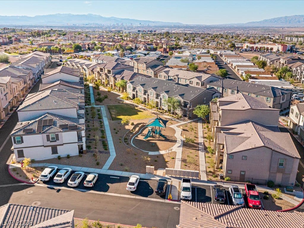 671 Foam Flower Lane, Henderson, NV 89015 A well-planned community courtyard features a central playground nestled among residential buildings.