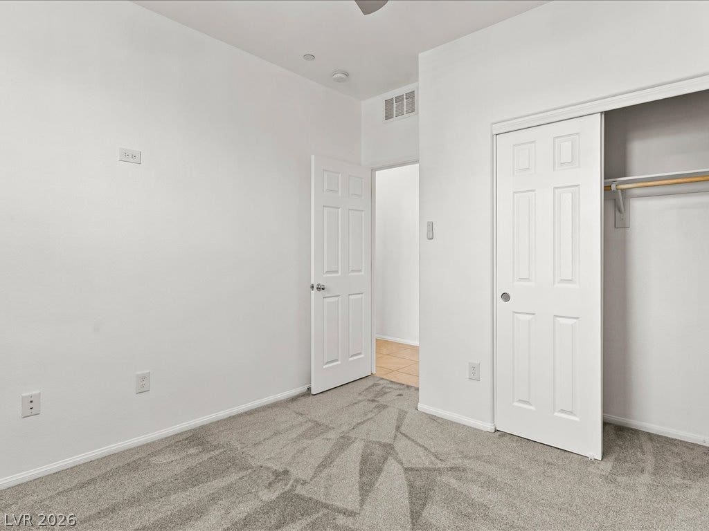 671 Foam Flower Lane, Henderson, NV 89015 Plush carpeting and a built-in closet with sliding doors anchor this versatile secondary bedroom.