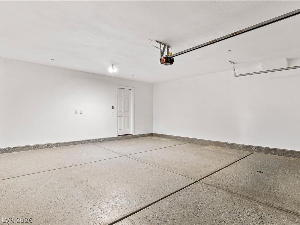 671 Foam Flower Lane, Henderson, NV 89015 An immaculate garage with textured concrete flooring provides ample space and a clean layout.